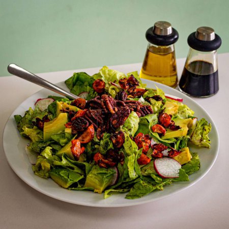 Photo for "avocado, lettuce and walnuts salad with dressing" - Royalty Free Image