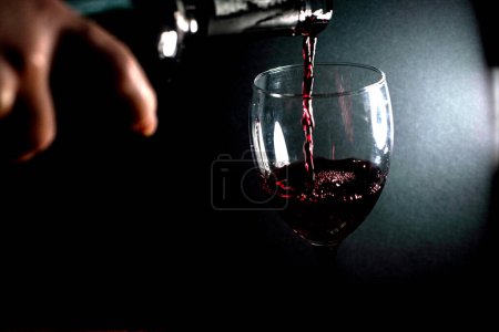 Photo for Pouring red wine into a glass - Royalty Free Image