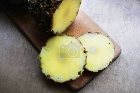 Photo for Pineapple sliced on a wooden board - Royalty Free Image
