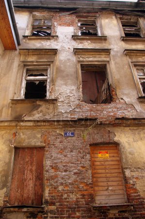 Photo for "Derelict building in Kazimierz with broken windows and exposed brickwork" - Royalty Free Image