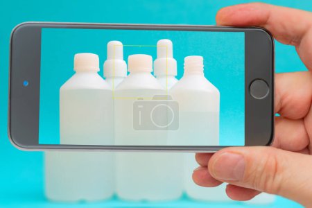 Photo for Antiseptic vials on smartphone screen. Disinfectant liquid - Royalty Free Image