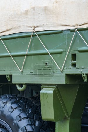 Photo for Side of a dark green military truck with an awning - Royalty Free Image