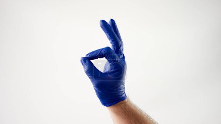 Photo for Doctors hand in a medical glove,makes a gesture,everything will be okay - Royalty Free Image