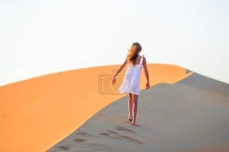 Photo for Girl among dunes in Rub al-Khali desert in United Arab Emirates - Royalty Free Image