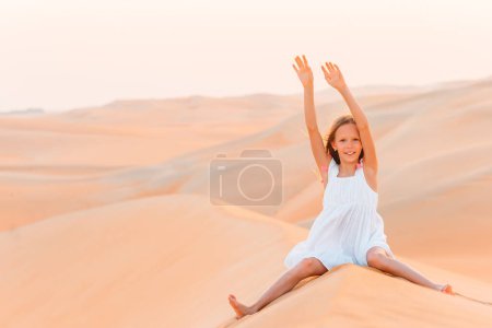 Photo for Girl among dunes in Rub al-Khali desert in United Arab Emirates - Royalty Free Image
