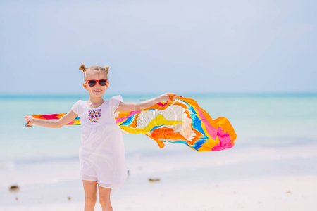 Photo for Happy little girl having fun running with pareo on tropical white beach - Royalty Free Image