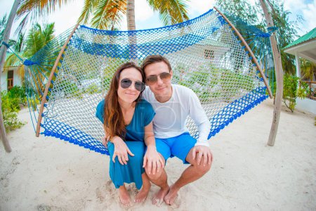 Photo for Family on summer vacation relaxing in hammock - Royalty Free Image