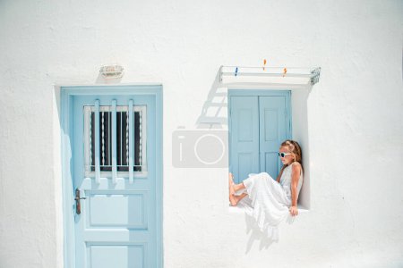 Photo for Adorable girl at old street of typical greek traditional village - Royalty Free Image