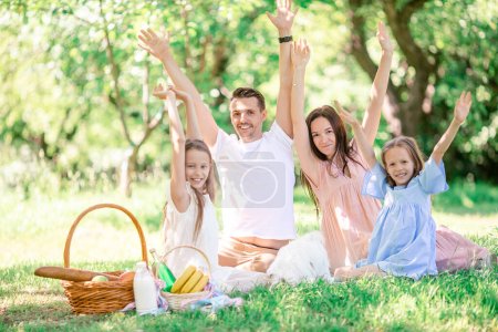 Foto de Familia feliz en un picnic en el parque en un día soleado - Imagen libre de derechos