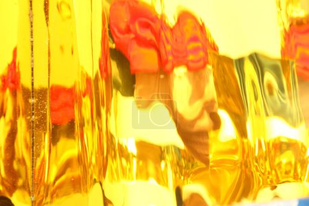 Foto de Abstracto de vidrio dorado con fondo rojo y amarillo - Imagen libre de derechos