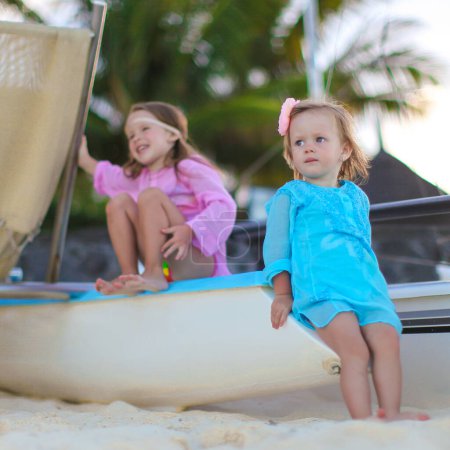 Téléchargez les photos : Adorables petites filles s'amusent sur la plage blanche pendant les vacances - en image libre de droit