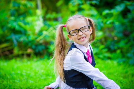 Photo for Little happy girl going back to school outdoor - Royalty Free Image