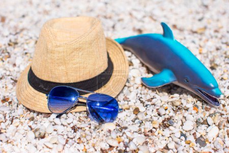 Photo for Hat, sunglasses and a toy on the sand - Royalty Free Image