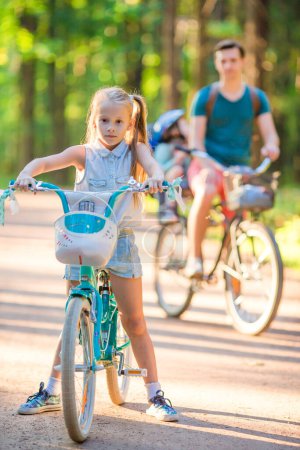 Photo for Happy family riding bicycles outdoors - Royalty Free Image