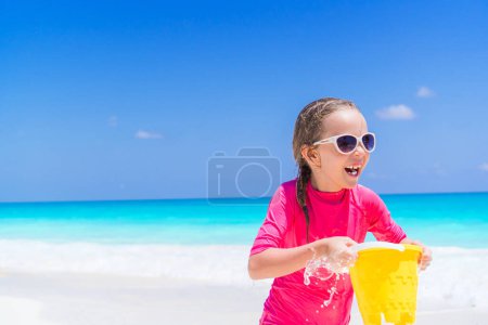 Photo for Little adorable girl playing on beach with ball - Royalty Free Image