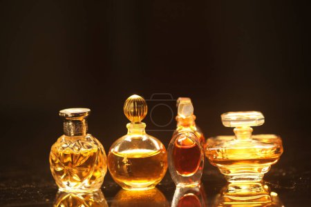 Téléchargez les photos : Flacons de parfum avec bouchon doré sur fond noir. - en image libre de droit