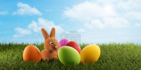 Foto de Un pequeño conejito de Pascua joven lindo y huevos de colores 3d-ilustración - Imagen libre de derechos