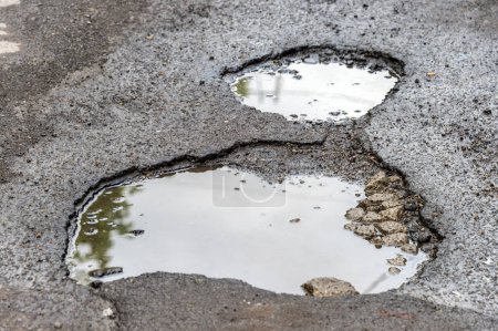 Photo for Large rounded pothole filled with water in Montreal - Royalty Free Image