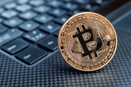 Photo for "Bitcoin cryptocurrency golden coin on a keyboard" - Royalty Free Image