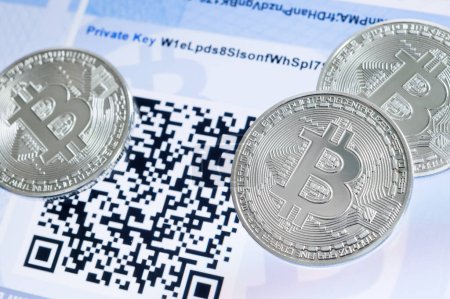 Foto de Criptomoneda Bitcoin monedas metálicas, código QR y billetera de papel. - Imagen libre de derechos