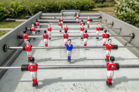 Photo for Outdoor table football showing only one blue player. - Royalty Free Image