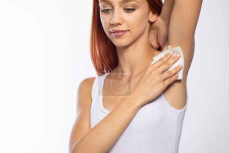 Photo for Young girl wiping the armpit with wet wipes - Royalty Free Image