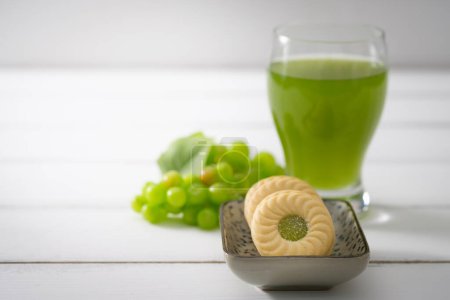 Photo for Glass of tasty fresh green tea and fresh kiwi on table - Royalty Free Image