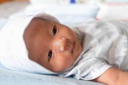 Foto de "Portrait Photo of happy newborn baby infant with big black eyes " - Imagen libre de derechos