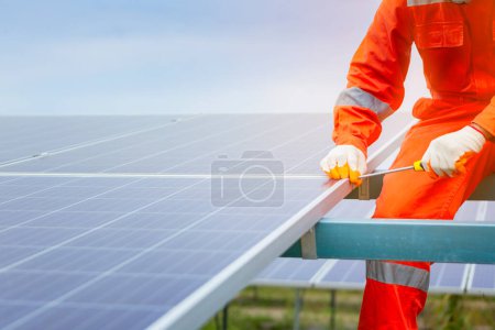 Photo for Engineers and workers in uniform and installs solid solar panels - Royalty Free Image