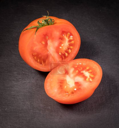 Photo for Tomato sliced on a slate stone - Royalty Free Image