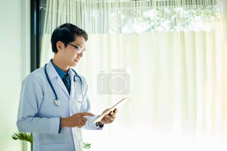 Photo for The portrait of a young doctor working seriously in the doctor's - Royalty Free Image