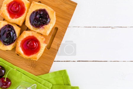 Photo for Homemade blueberry jam and bread on wooden board. top view - Royalty Free Image