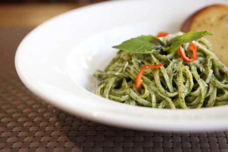 Photo for "spaghetti with pesto sauce on wood background" - Royalty Free Image