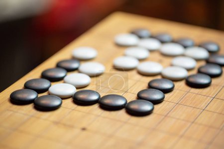 Photo for Go board game playing. A competitor is placing a marble piece on - Royalty Free Image