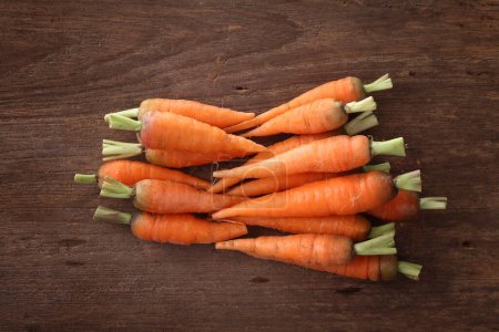 Photo for Carrots isolated in wood background - Royalty Free Image