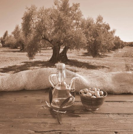 Photo for Olive oil and olives on table in garden - Royalty Free Image
