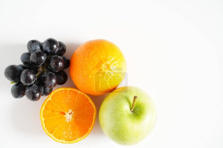 Photo for An Apple, Orange and Grapes - Royalty Free Image