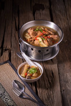 Photo for "Chicken and herb soup in pot" - Royalty Free Image