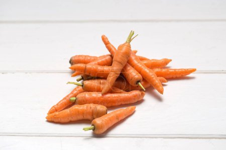 Photo for Baby carrot vegetarian food on wooden table - Royalty Free Image