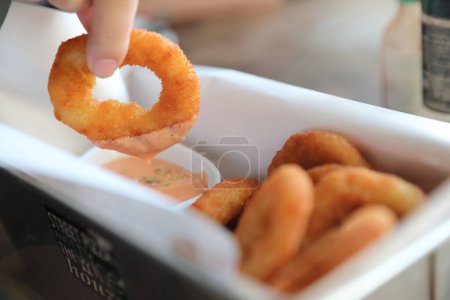Photo for Onion rings with sauce on wooden table - Royalty Free Image