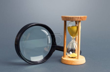 Photo for Magnifying glass and hourglass. Limited Search Concept. Find free time. Subscription, paid plan. Seek in short time. Speed and efficiency. Deadline - Royalty Free Image