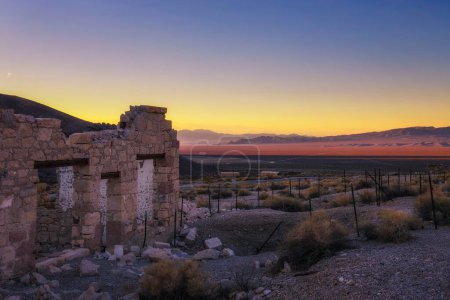 Téléchargez les photos : Lever de soleil au-dessus d'un bâtiment abandonné à Rhyolite, Nevada - en image libre de droit