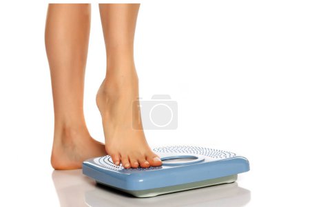 Photo for Pretty female legs on scales - Royalty Free Image