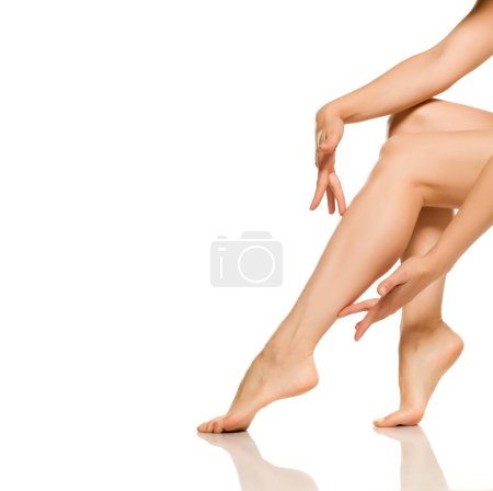 Foto de Woman touching her beautifully groomed legs - Imagen libre de derechos
