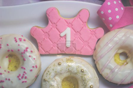 Photo for "First birthday cookies - royal icing crown shape cookie and deco" - Royalty Free Image