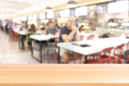 Photo for "wood plank on blur canteen dining hall room, empty wood table floors on a lot of people are eating food in university canteen blur background, wood table board empty on blur cafe or cafeteria canteen" - Royalty Free Image