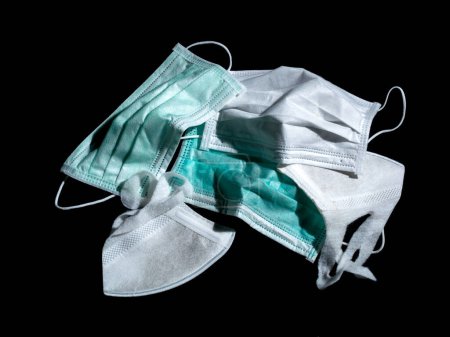 Photo for "used surgical masks and used PM2.5 masks place on black background." - Royalty Free Image
