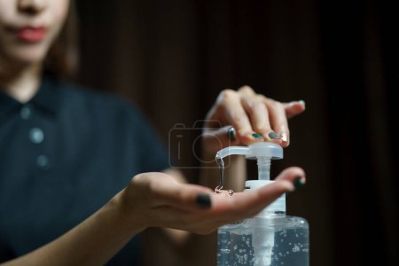 Photo for Hands using wash hand sanitizer gel pump dispenser. - Royalty Free Image