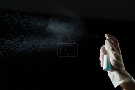 Foto de Hand using sanitizer spray, alcohol spraying disinfectant - Imagen libre de derechos