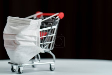 Photo for Shopping cart with protective face mask corona virus or Covid-19 - Royalty Free Image